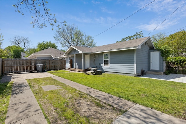 back of house with fence and a lawn