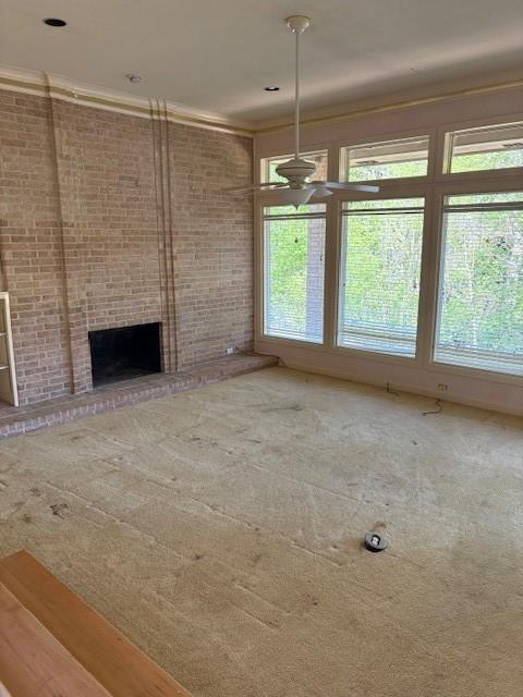 1417 Wyndmere Dr, Desoto, TX 75115 - unfurnished living room featuring crown molding, a fireplace, a wealth of natural light, and carpet floors