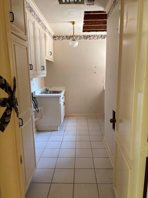 1417 Wyndmere Dr, Desoto, TX 75115 - clothes washing area featuring light tile patterned floors, baseboards, and a sink