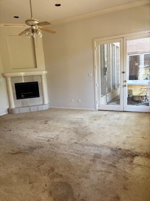 1417 Wyndmere Dr, Desoto, TX 75115 - unfurnished living room with a tile fireplace, carpet, crown molding, and ceiling fan