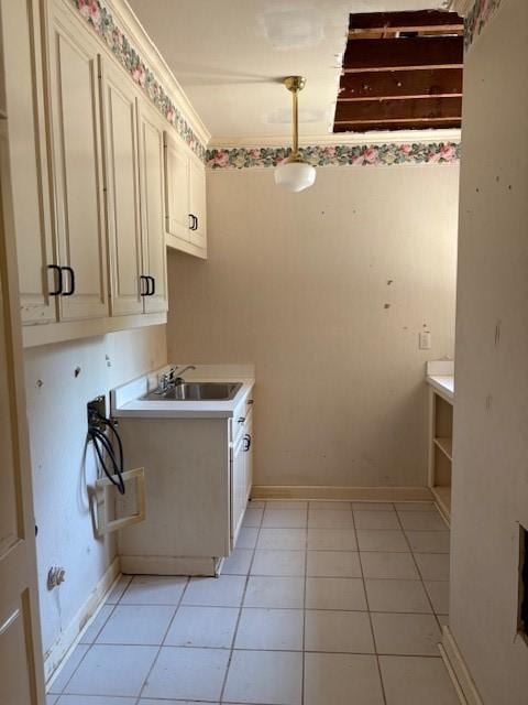 1417 Wyndmere Dr, Desoto, TX 75115 - laundry area featuring baseboards, washer hookup, a sink, cabinet space, and light tile patterned flooring