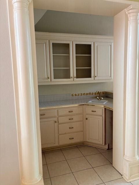 1417 Wyndmere Dr, Desoto, TX 75115 - interior space with decorative columns, a sink, and light tile patterned floors
