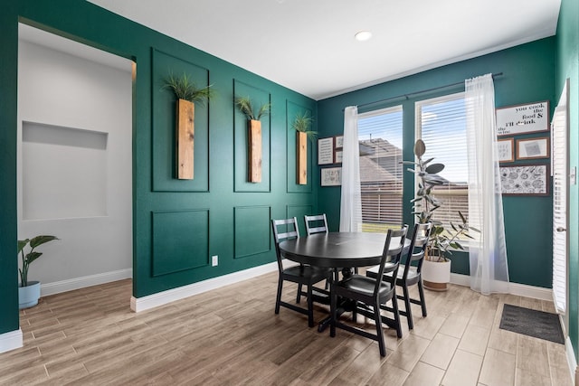 dining area featuring light wood-style floors and baseboards