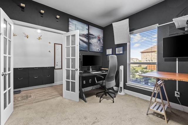 carpeted office space with french doors and baseboards