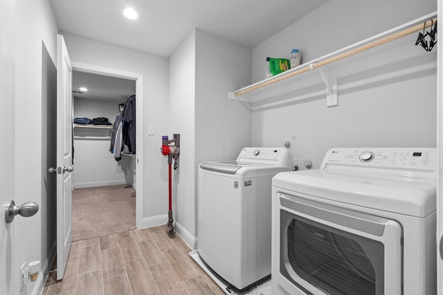 laundry area featuring baseboards, laundry area, independent washer and dryer, recessed lighting, and light wood finished floors
