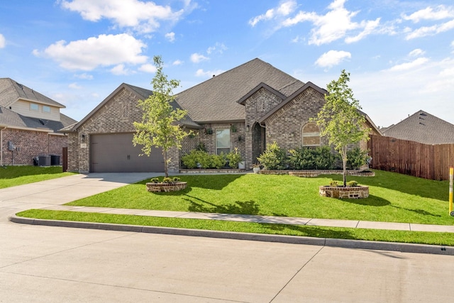 view of front facade with an attached garage, driveway, fence, and brick siding