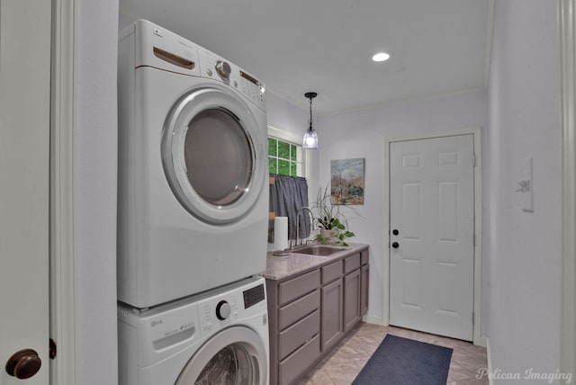 washroom with a sink, ornamental molding, laundry area, stacked washer and dryer, and marble finish floor
