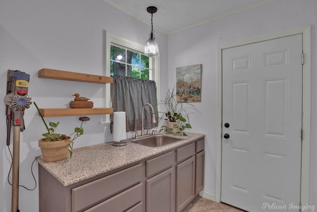 interior space featuring light tile patterned floors, a sink, and crown molding