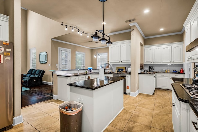 kitchen with a peninsula, light tile patterned floors, white cabinetry, and stainless steel appliances