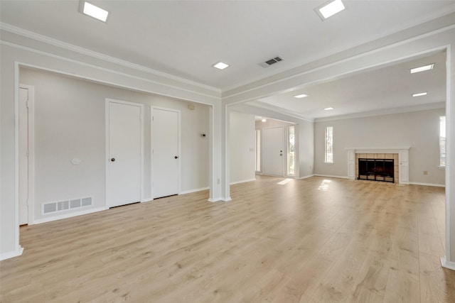 unfurnished living room featuring crown molding, visible vents, and light wood-type flooring