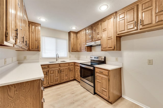 kitchen with stainless steel electric range, under cabinet range hood, light wood-type flooring, and a sink
