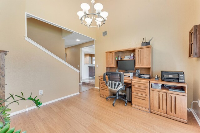 office with baseboards, light wood-type flooring, a notable chandelier, and visible vents