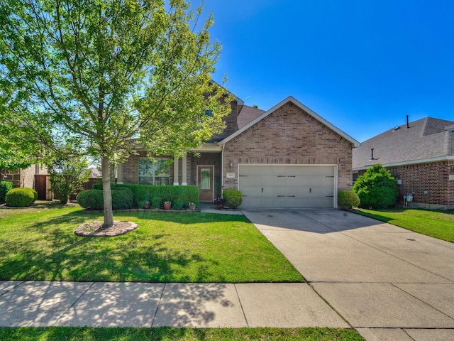 view of front of property with an attached garage, concrete driveway, a front yard, and brick siding