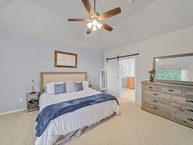 bedroom featuring light carpet, baseboards, vaulted ceiling, and a barn door