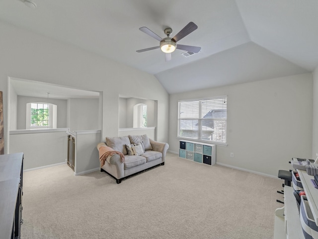 carpeted living room with visible vents, baseboards, vaulted ceiling, and a ceiling fan