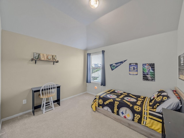 carpeted bedroom with baseboards and vaulted ceiling