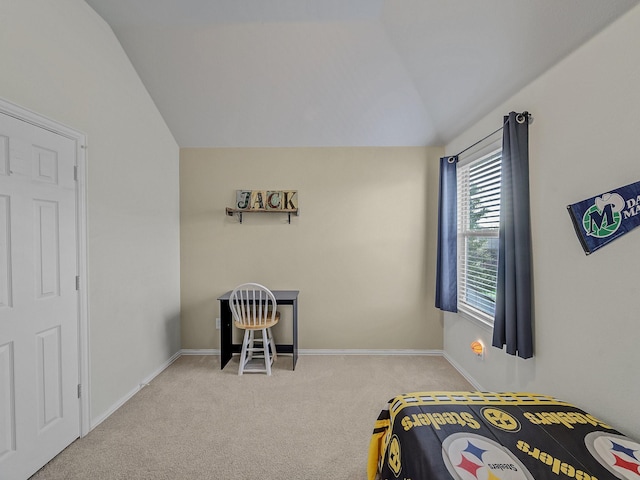 carpeted bedroom with baseboards and vaulted ceiling