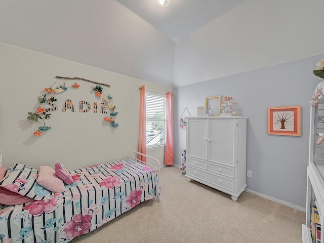 carpeted bedroom featuring baseboards and lofted ceiling