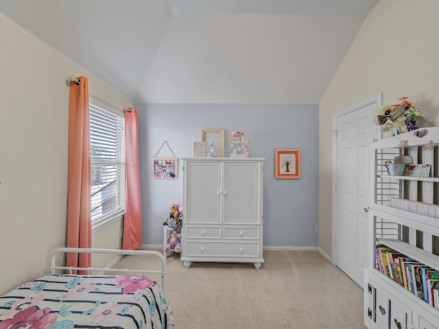 bedroom with baseboards, light colored carpet, and vaulted ceiling