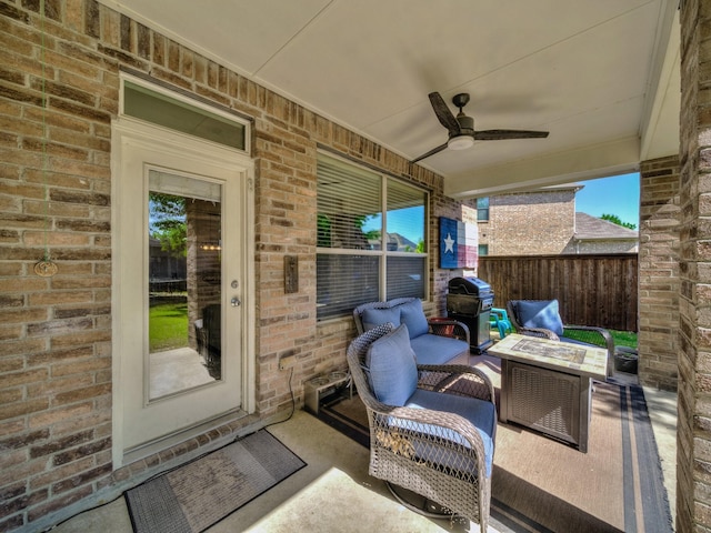 view of patio / terrace with grilling area, fence, and a ceiling fan