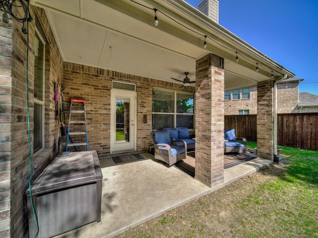 view of patio with an outdoor hangout area, ceiling fan, fence, and heating unit