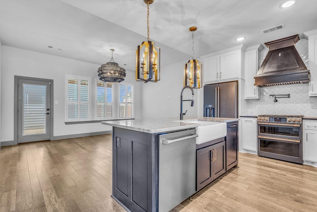14229 Walsh Ave, Fort Worth, TX 76008 - kitchen featuring appliances with stainless steel finishes, custom range hood, white cabinetry, backsplash, and light wood finished floors
