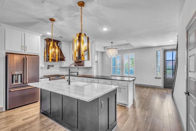 14229 Walsh Ave, Fort Worth, TX 76008 - kitchen with appliances with stainless steel finishes, a sink, a chandelier, light wood finished floors, and white cabinets