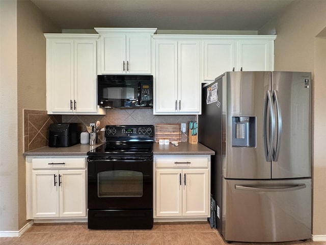 kitchen with dark countertops, white cabinets, light tile patterned flooring, decorative backsplash, and black appliances