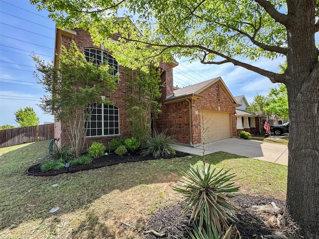 view of front facade with a garage, fence, concrete driveway, and brick siding