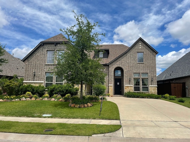 2018 Barley Place Dr, Allen, TX 75013 - view of front facade featuring brick siding, a front yard, a shingled roof, and stone siding