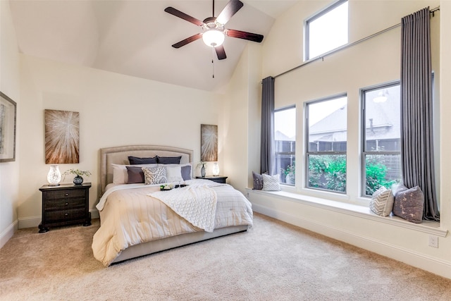 carpeted bedroom featuring baseboards, high vaulted ceiling, a ceiling fan, and multiple windows