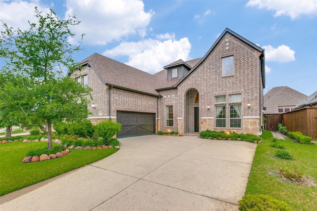 2018 Barley Place Dr, Allen, TX 75013 - tudor-style house featuring brick siding, driveway, a garage, stone siding, and roof with shingles