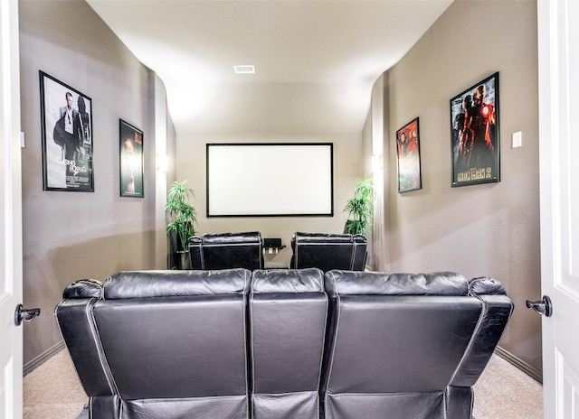 carpeted cinema room with visible vents and baseboards