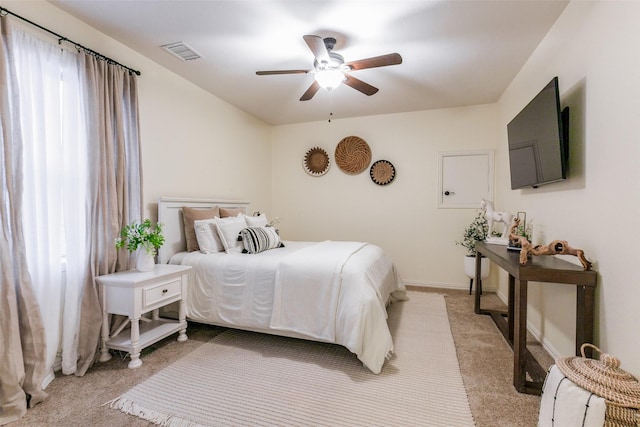 bedroom with visible vents, ceiling fan, light carpet, and baseboards