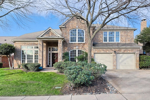 501 Maple Leaf Ln, Mckinney, TX 75071 - traditional home featuring driveway, a front yard, an attached garage, and brick siding