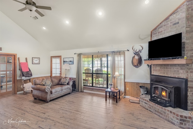 living room featuring visible vents, baseboards, ceiling fan, wood finished floors, and high vaulted ceiling