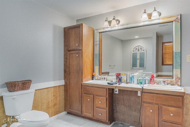 full bathroom featuring toilet, vanity, and tile patterned flooring
