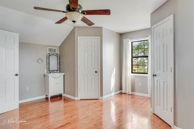 unfurnished bedroom with visible vents, baseboards, ceiling fan, and light wood-style floors
