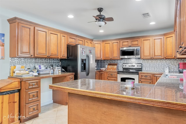kitchen featuring tasteful backsplash, visible vents, ceiling fan, tile countertops, and appliances with stainless steel finishes