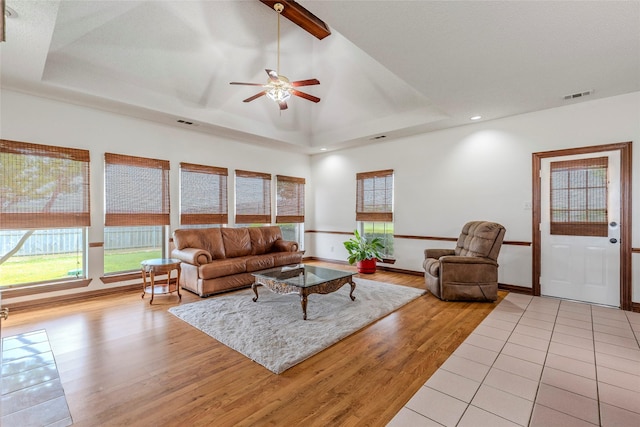 living area featuring ceiling fan, visible vents, a tray ceiling, recessed lighting, and light wood-style flooring
