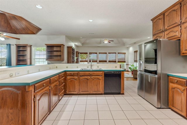kitchen with ceiling fan, a sink, black dishwasher, a healthy amount of sunlight, and stainless steel refrigerator with ice dispenser