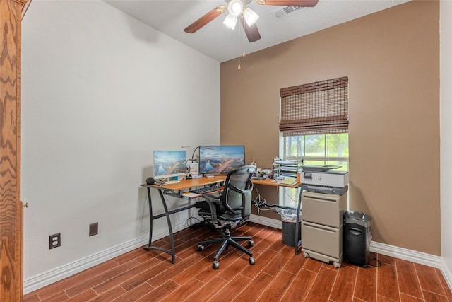 home office featuring baseboards, ceiling fan, wood finished floors, and visible vents