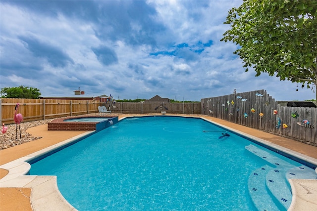 view of pool with a fenced backyard, a pool with connected hot tub, and a patio area