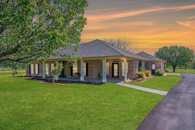 104 Fm 2450, Krum, TX 76249 - single story home featuring covered porch, a lawn, a shingled roof, and brick siding