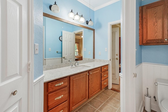 104 Fm 2450, Krum, TX 76249 - bathroom with ornamental molding, vanity, wainscoting, toilet, and tile patterned floors