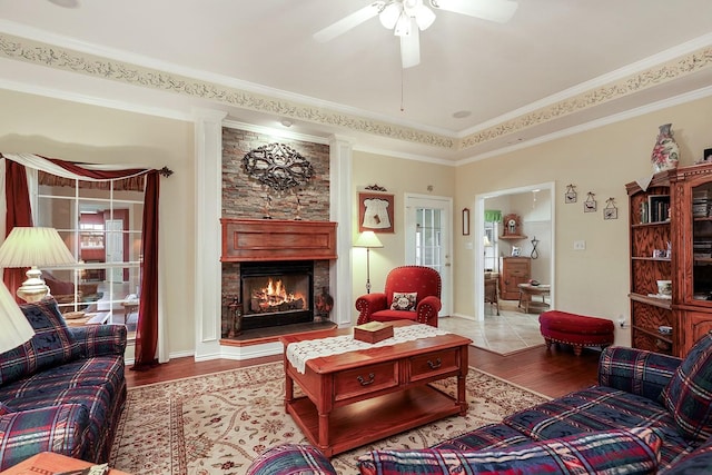 104 Fm 2450, Krum, TX 76249 - living area with wood finished floors, ceiling fan, a stone fireplace, and crown molding