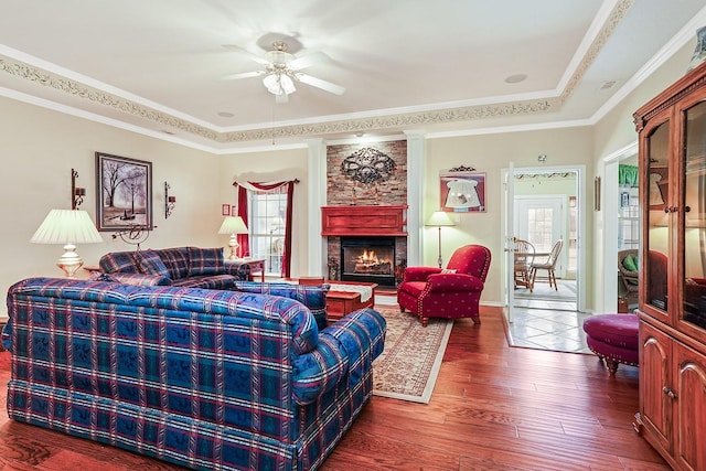 104 Fm 2450, Krum, TX 76249 - living room with wood finished floors, plenty of natural light, a large fireplace, a ceiling fan, and ornamental molding