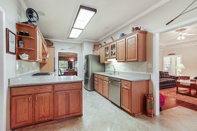 104 Fm 2450, Krum, TX 76249 - kitchen featuring appliances with stainless steel finishes, a sink, crown molding, a ceiling fan, and decorative backsplash