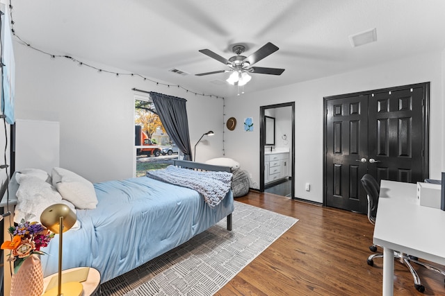 bedroom with wood finished floors, ensuite bath, and a ceiling fan