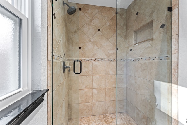 full bathroom with a stall shower and a textured wall